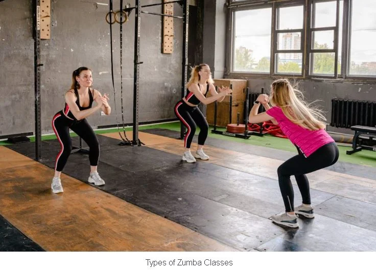 A woman participating in a group Zumba dance workout in a fitness gym.