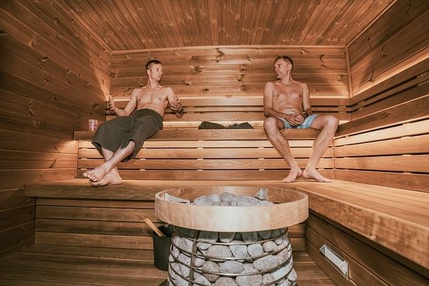 sauna-bath-feature-image sauna, two maen sit in sauna bath room and talk to each other.