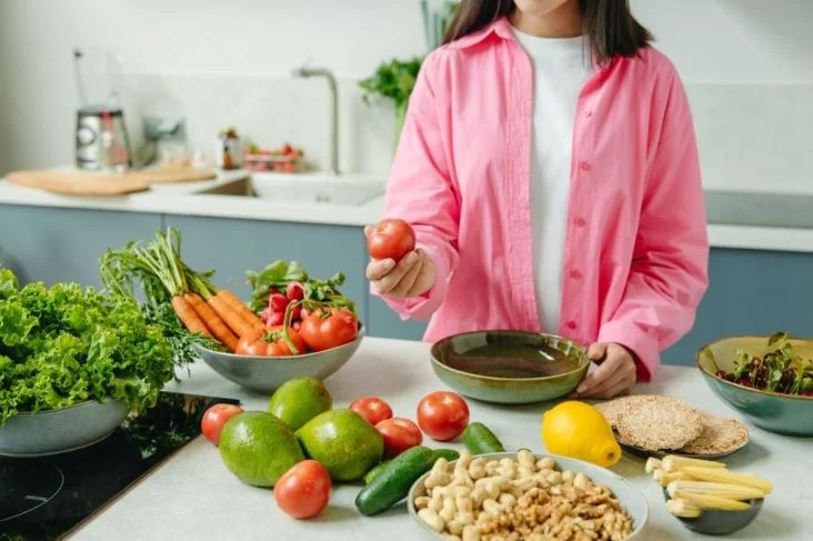 a girl look at the fresh vegetable,which is good for lungs health.